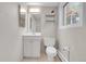 Bright bathroom featuring a white vanity with storage, modern fixtures, and a window providing natural light at 960 S Arbutus St, Lakewood, CO 80228