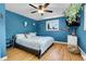 A cozy bedroom featuring a ceiling fan, and a large window with hanging plants at 960 S Arbutus St, Lakewood, CO 80228