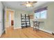 Bedroom featuring hardwood floors, a ceiling fan, and a window with a purple valance at 960 S Arbutus St, Lakewood, CO 80228
