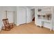 Bedroom featuring hardwood floors and a white desk with built-in shelving at 960 S Arbutus St, Lakewood, CO 80228