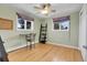 Bedroom featuring hardwood floors, a ceiling fan, and two windows with purple valances at 960 S Arbutus St, Lakewood, CO 80228