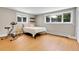 Bright bedroom with hardwood floors, an exercise bike, and natural light from three windows at 960 S Arbutus St, Lakewood, CO 80228