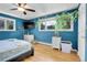 A blue bedroom with two dressers and two windows providing natural light at 960 S Arbutus St, Lakewood, CO 80228