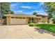Charming brick home featuring a two-car garage, covered entryway, and well-manicured lawn at 960 S Arbutus St, Lakewood, CO 80228