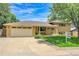 Charming brick home with a well-manicured lawn, mature trees, and a two-car garage at 960 S Arbutus St, Lakewood, CO 80228