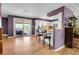 Bright kitchen open to living area with a breakfast bar, modern appliances, and a sliding patio door at 960 S Arbutus St, Lakewood, CO 80228