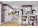 Bright kitchen with white appliances, breakfast bar, and purple accent walls at 960 S Arbutus St, Lakewood, CO 80228