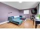 Cozy living room with a blue tufted sofa, hardwood floors, and a modern design at 960 S Arbutus St, Lakewood, CO 80228