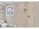 Bathroom featuring a tiled shower with a niche and a rainfall shower head at 960 S Arbutus St, Lakewood, CO 80228
