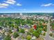 An aerial view shows mature tree coverage around this home near a metropolitan area at 1080 S Garfield St, Denver, CO 80209