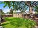 View of a spacious backyard featuring a detached single car garage and plentiful green space at 1080 S Garfield St, Denver, CO 80209