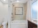 Modern bathroom featuring a bathtub with shower, tile accents, and granite countertop at 1080 S Garfield St, Denver, CO 80209