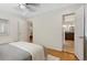 Bright bedroom with hardwood floors, access to a bathroom, and a glimpse into a dining area at 1080 S Garfield St, Denver, CO 80209