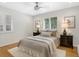 Comfortable bedroom with hardwood floors, natural light, and neutral decor at 1080 S Garfield St, Denver, CO 80209
