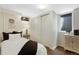 Cozy bedroom with a comfortable bed, window, decorative floral artwork, and a closet with sliding doors at 1080 S Garfield St, Denver, CO 80209
