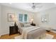 Comfortable bedroom with neutral tones, plush bedding, and a ceiling fan provides a relaxing space at 1080 S Garfield St, Denver, CO 80209