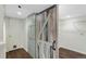 Spacious walk-in closet with custom shelving, barn door, and hardwood flooring, for optimum organization at 1080 S Garfield St, Denver, CO 80209