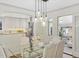 Bright dining area with modern lighting adjacent to an open kitchen at 1080 S Garfield St, Denver, CO 80209