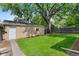 View of a spacious backyard featuring a detached single car garage and plentiful green space at 1080 S Garfield St, Denver, CO 80209