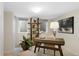 A serene home office featuring a modern desk, stylish decor, ample natural light, and neutral carpet at 1080 S Garfield St, Denver, CO 80209