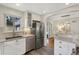 This kitchen features stainless appliances, white cabinets, and an open layout to the dining area at 1080 S Garfield St, Denver, CO 80209