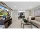 Inviting living room with sleek furniture, a glass coffee table, and a decorative faux wood accent wall with large screen TV at 1080 S Garfield St, Denver, CO 80209