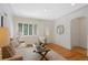 Cozy living room featuring hardwood floors, white walls, and stylish neutral furnishings at 1080 S Garfield St, Denver, CO 80209