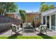 Inviting patio area with stylish furniture, a privacy fence, a view of the surrounding landscape and blue sky at 1080 S Garfield St, Denver, CO 80209