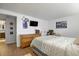 Spacious bedroom with a dresser and mounted TV, offering a comfortable and functional living space at 1260 York St # 102, Denver, CO 80206