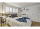 Comfortable bedroom featuring a large window, cozy bed, and shelving for added storage and decor at 1260 York St # 102, Denver, CO 80206