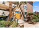 Charming stone accented building entrance featuring unique architectural details and inviting landscaping at 1260 York St # 102, Denver, CO 80206
