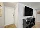View of the home's entryway with wood floors and a white door, complemented by a sleek black entertainment center at 1260 York St # 102, Denver, CO 80206