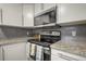 Well-lit kitchen area with granite countertops, stainless steel appliances, and ample cabinet space at 1260 York St # 102, Denver, CO 80206