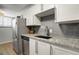 Updated kitchen showcasing granite countertops, stainless steel appliances, and modern white cabinetry at 1260 York St # 102, Denver, CO 80206