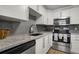 Charming kitchen features white cabinetry, stainless steel appliances, and granite countertops for a modern feel at 1260 York St # 102, Denver, CO 80206