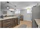 Open living space with a kitchen island, leather furniture, bar cart, and large windows at 1260 York St # 102, Denver, CO 80206