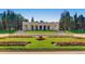 Beautiful park featuring manicured lawns, colorful flower beds, and a classical colonnade structure at 1260 York St # 102, Denver, CO 80206