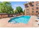 Relax by the community pool surrounded by lush greenery and comfortable lounge chairs at 1260 York St # 102, Denver, CO 80206