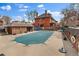 View of the community pool covered for the off-season next to the brick apartment building at 1260 York St # 102, Denver, CO 80206