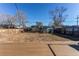 Spacious backyard featuring a deck, fence, shed, and clear blue skies at 7856 Ladore St, Commerce City, CO 80022