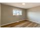 Bedroom with hardwood floors and a large window providing natural light at 7856 Ladore St, Commerce City, CO 80022