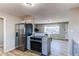 Stainless steel appliances including refrigerator and range in the modern updated kitchen at 7856 Ladore St, Commerce City, CO 80022