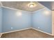 Spacious basement room with light blue walls and carpeted floor at 261 S Newark Cir, Aurora, CO 80012