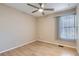 Simple bedroom with wood floors and window at 261 S Newark Cir, Aurora, CO 80012