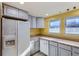 Galley kitchen with white cabinets and wood countertops at 261 S Newark Cir, Aurora, CO 80012