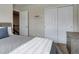 Bedroom with large closet, modern furniture, and neutral color scheme at 3070 Redhaven Way, Highlands Ranch, CO 80126