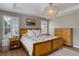 Bright, spacious bedroom with natural wood accents, ample windows and luxury lighting at 3070 Redhaven Way, Highlands Ranch, CO 80126
