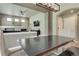Open dining area with hardwood floors, modern lighting, and seating with a view of the living room at 3070 Redhaven Way, Highlands Ranch, CO 80126