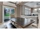 Well-lit dining area featuring a large wooden table and chairs with views to the yard at 3070 Redhaven Way, Highlands Ranch, CO 80126