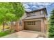 Two-story home featuring a brick and siding exterior, a two-car garage, and a well-maintained lawn at 3070 Redhaven Way, Highlands Ranch, CO 80126